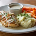 Dinner plate with baked ranch chicken, mashed potatoes, and veggies
